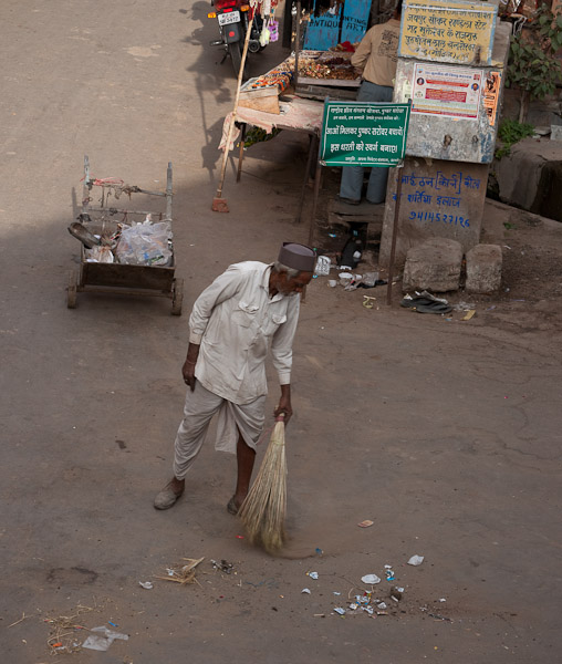 India_JanFeb_10_Pushkar_5984.jpg - Street sweeper  from where I ate breakfast.  They throw and empty trash into the streets.